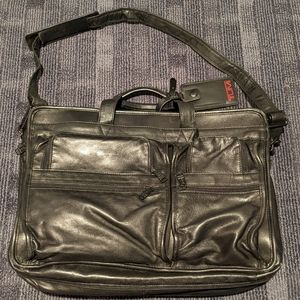 Black Tumi expandable briefcase. Fits 15" laptop notebook.